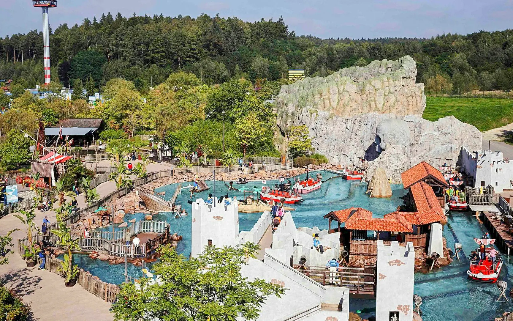 Pirate-themed water ride at Pirate Land, LEGOLAND® Billund with boats and castle structures.