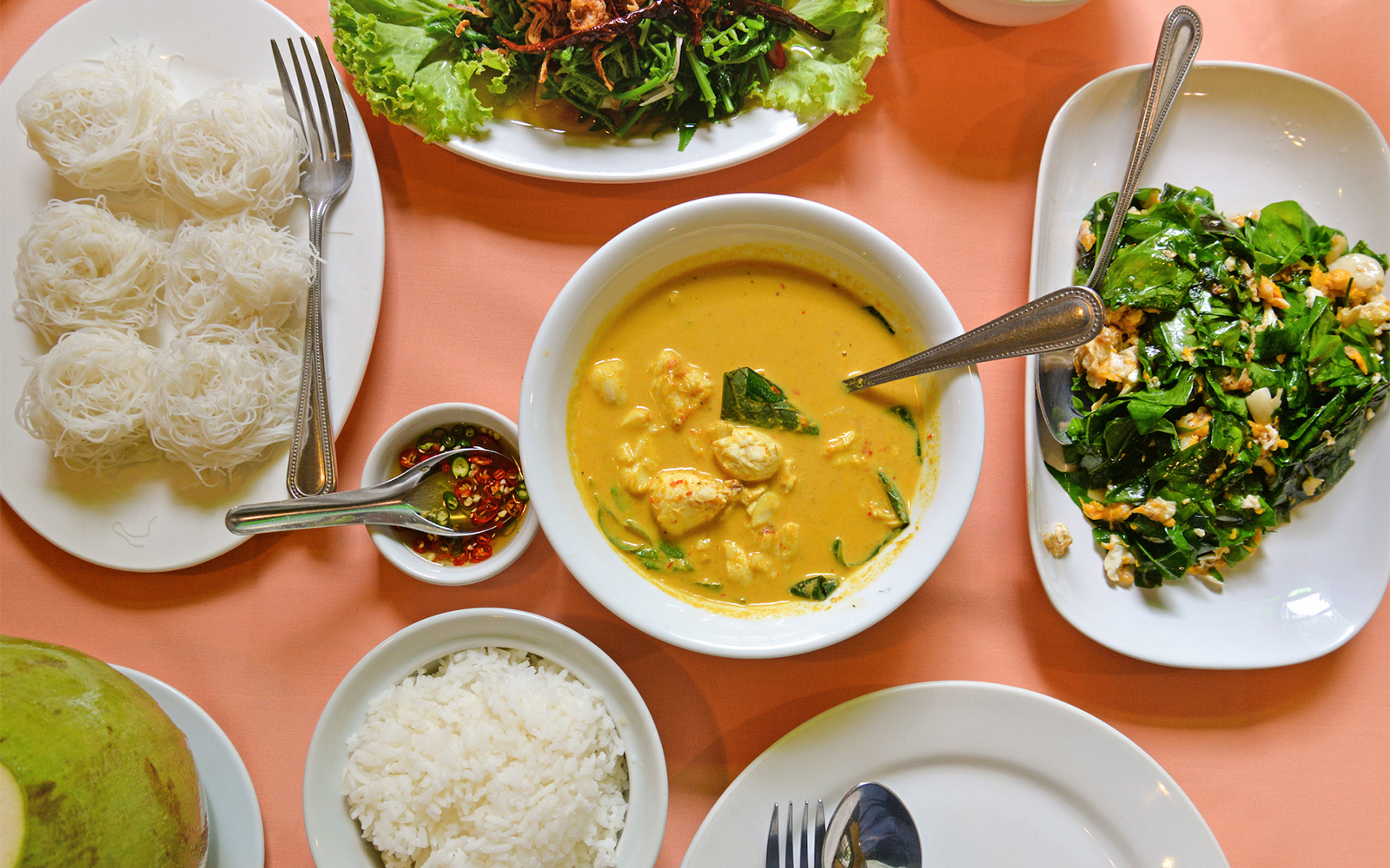 Traditional Thai meal with curry, rice, noodles, and vegetables on a Phuket tour.