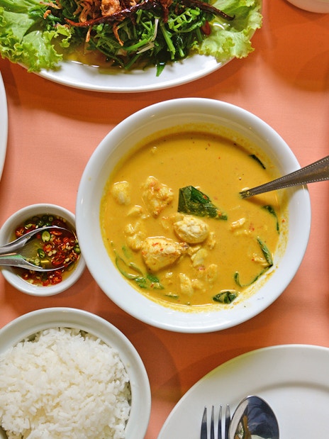 Traditional Thai meal with curry, rice, noodles, and vegetables on a Phuket tour.