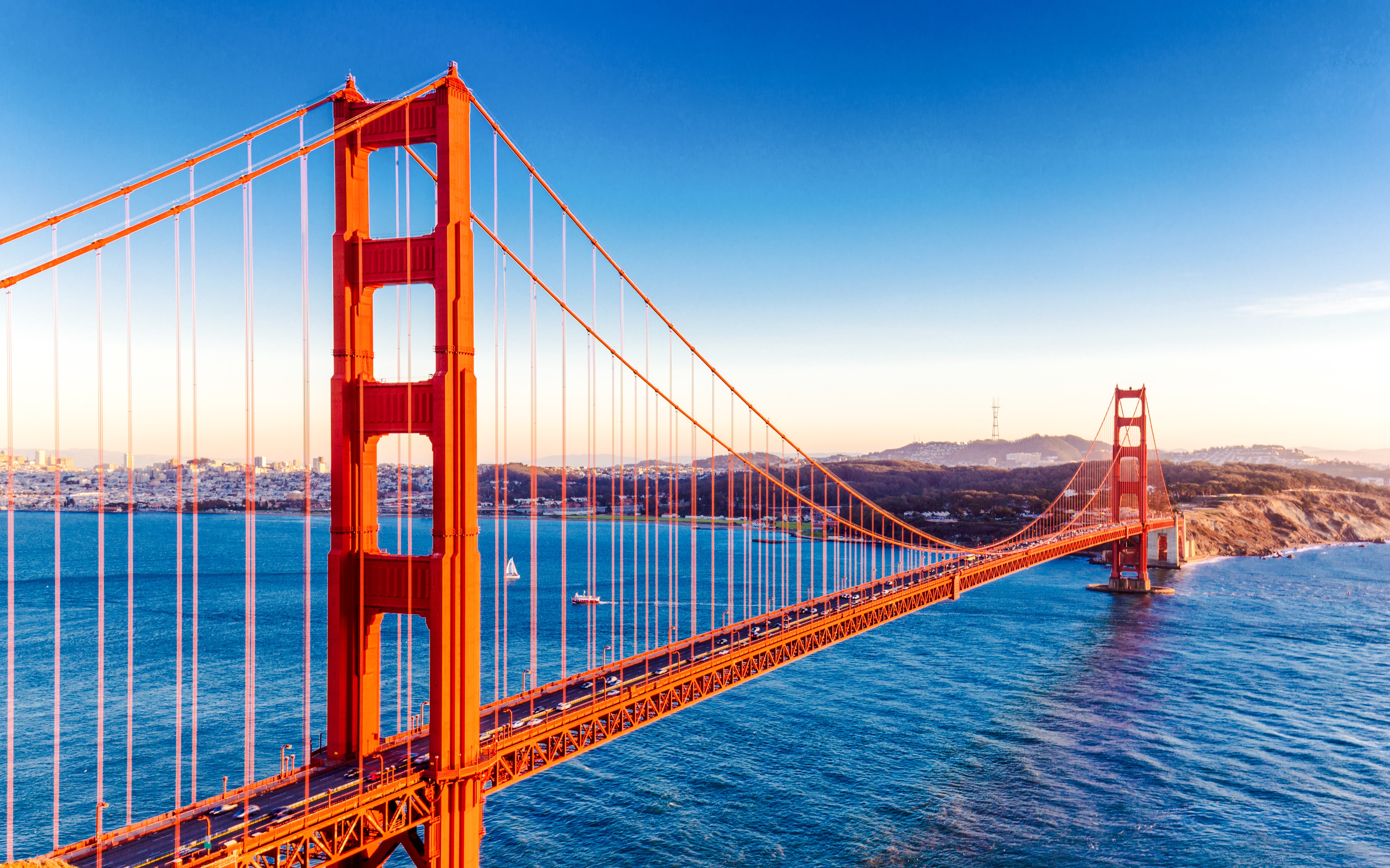 Golden Gate Bridge spanning San Francisco Bay at sunset.
