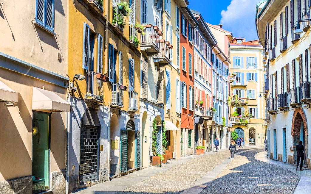 Brera Art District street view with colorful buildings in Milan during city walking tour.