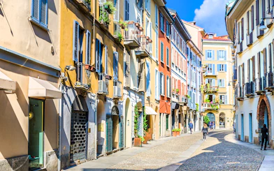 Brera Art District street view with colorful buildings in Milan during city walking tour.