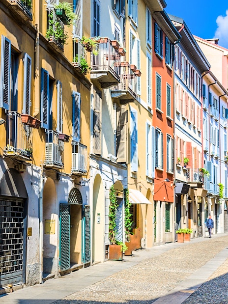 Brera Art District street view with colorful buildings in Milan during city walking tour.