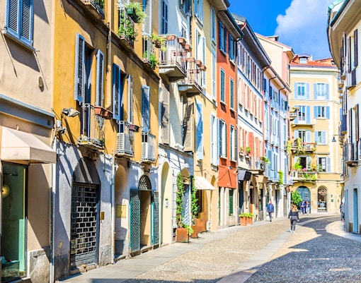 Brera Art District street view with colorful buildings in Milan during city walking tour.