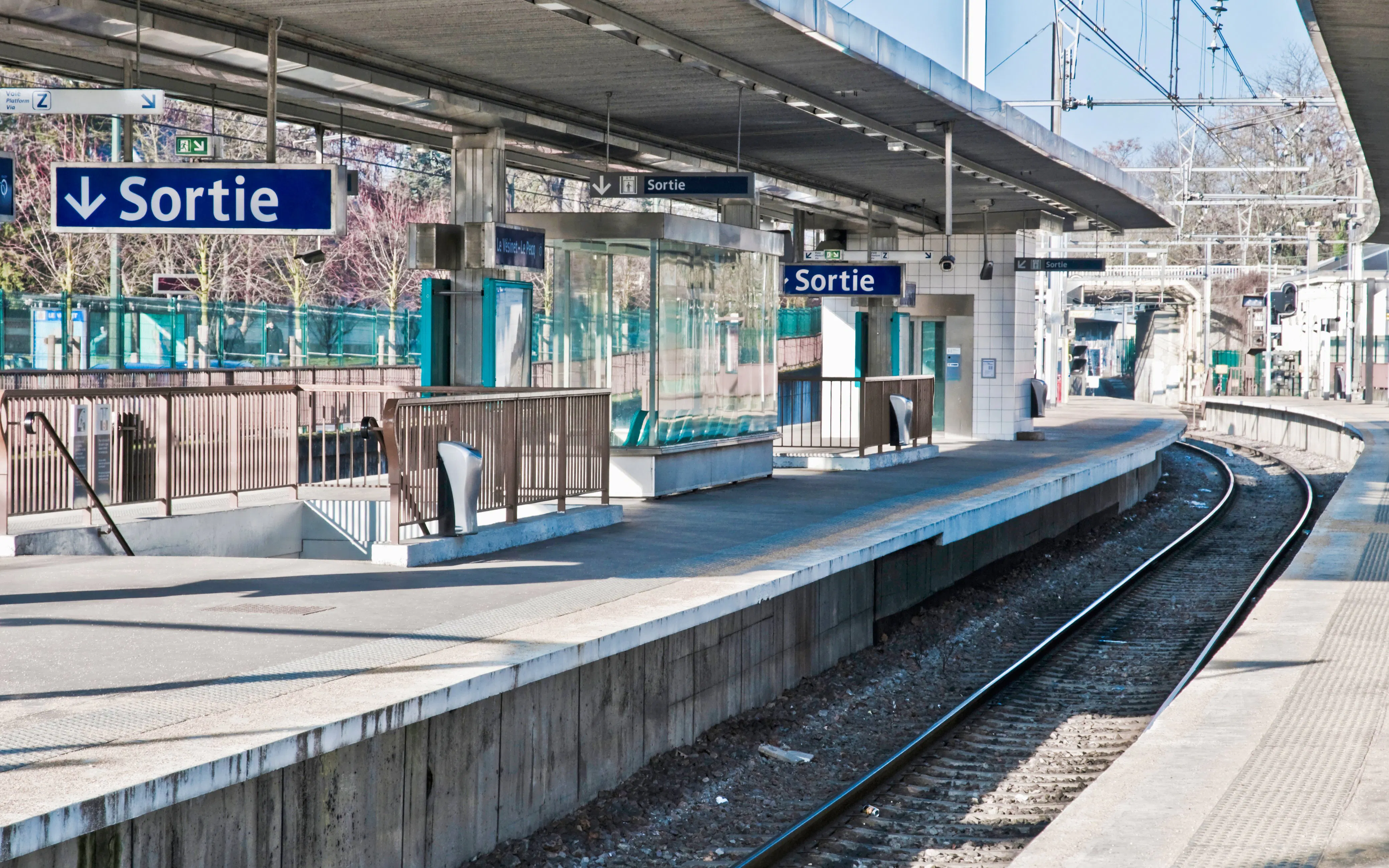 RER train platform in Paris, France, with signs for Disneyland Paris route.