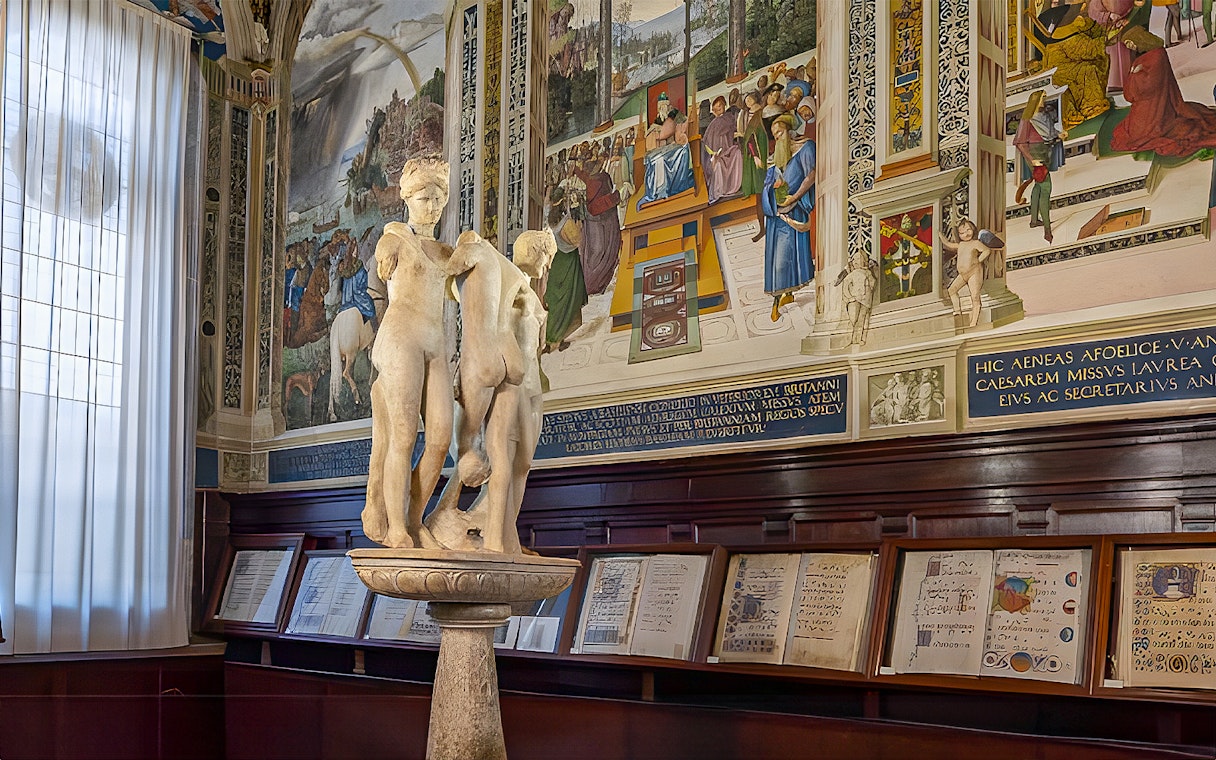 Sculpture and frescoes inside Siena Cathedral library, Italy.