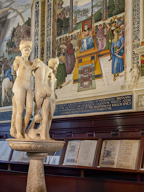 Sculpture and frescoes inside Siena Cathedral library, Italy.