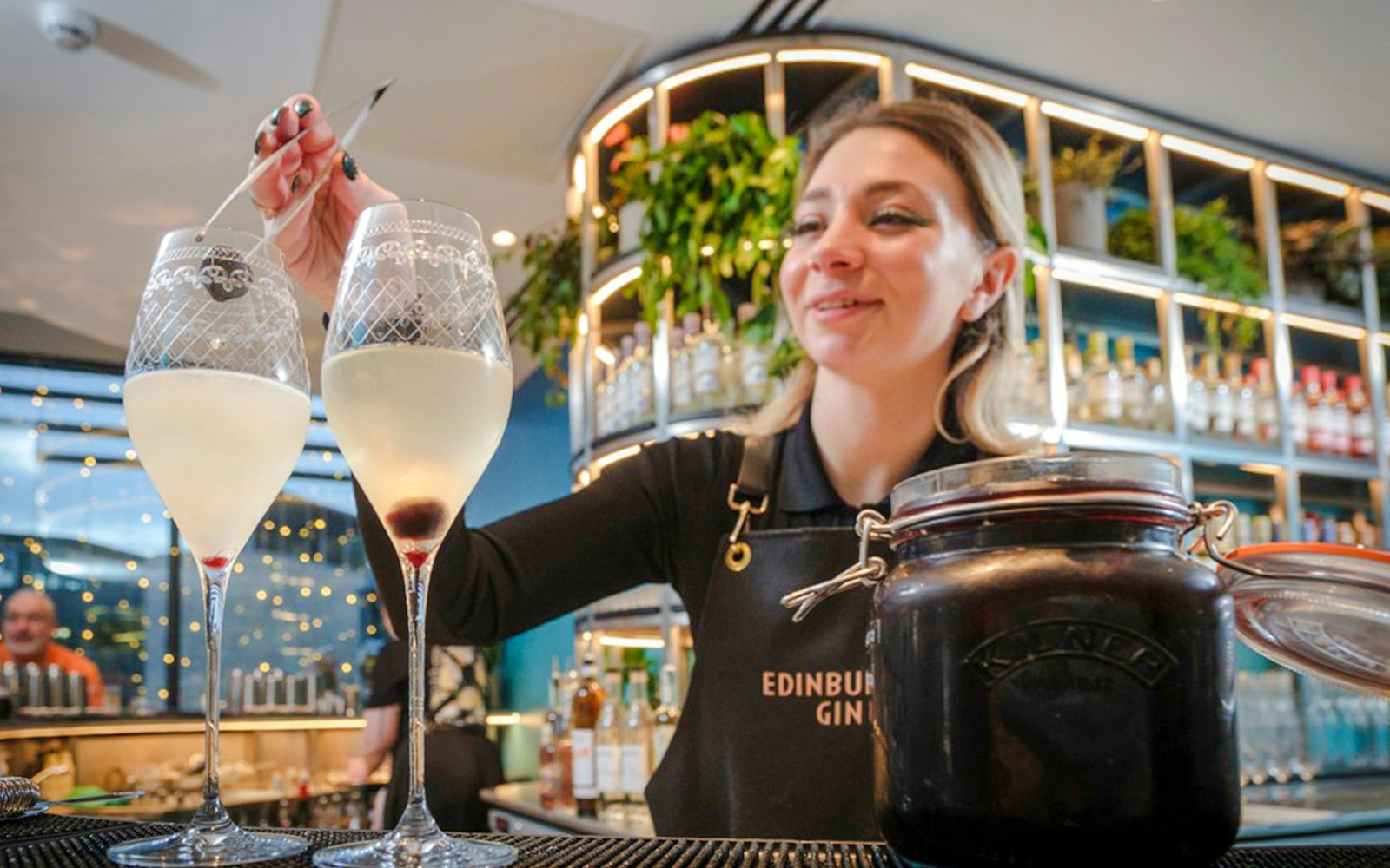 Bartender preparing cocktails at Edinburgh Gin Distillery bar.
