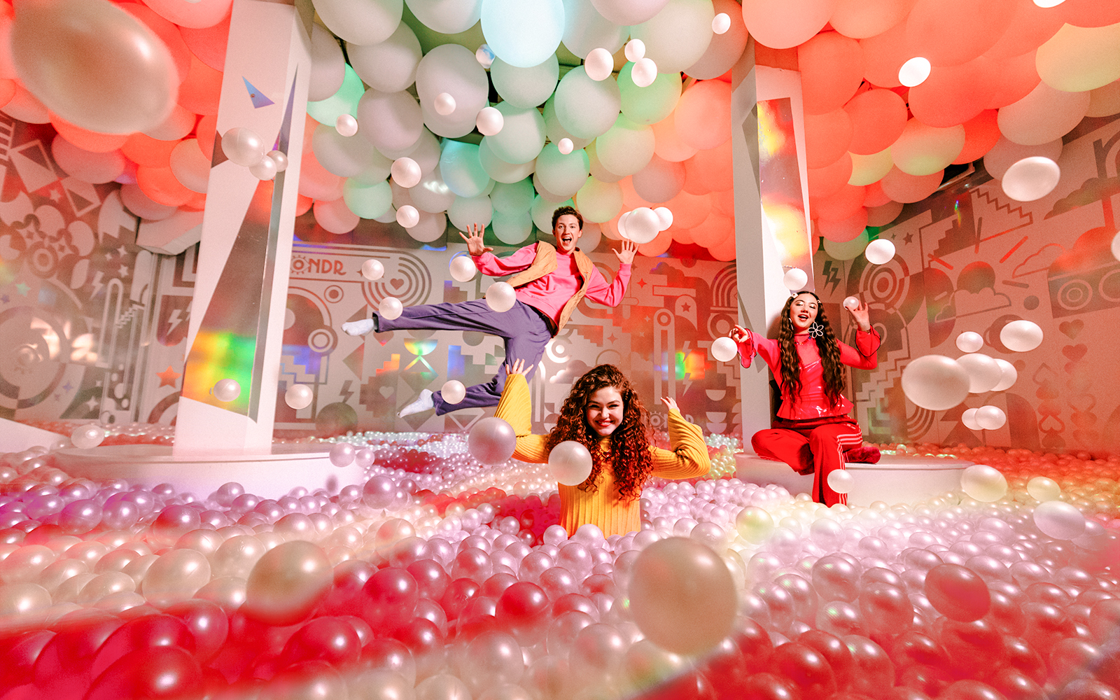 Guests enjoying colorful ball pit at WONDR Experience, Amsterdam.