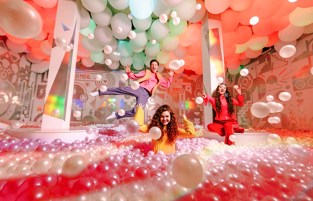 Guests enjoying colorful ball pit at WONDR Experience, Amsterdam.