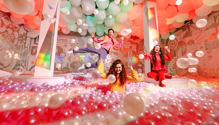 Guests enjoying colorful ball pit at WONDR Experience, Amsterdam.