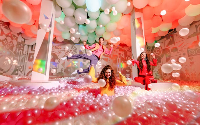 Guests enjoying colorful ball pit at WONDR Experience, Amsterdam.