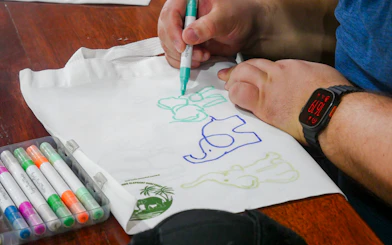 Drawing elephants on a tote bag at Krabi Roaming Elephant Sanctuary, Thailand.