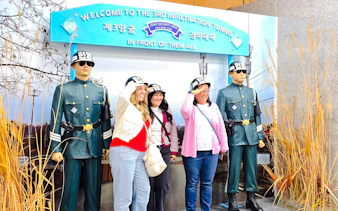 Women posing with statues at 3rd Infiltration Tunnel entrance, Seoul to DMZ tour, South Korea.