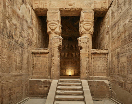 Interior of the Temple of Hathor, Dendera, Egypt, showing detailed hieroglyphics and columns.