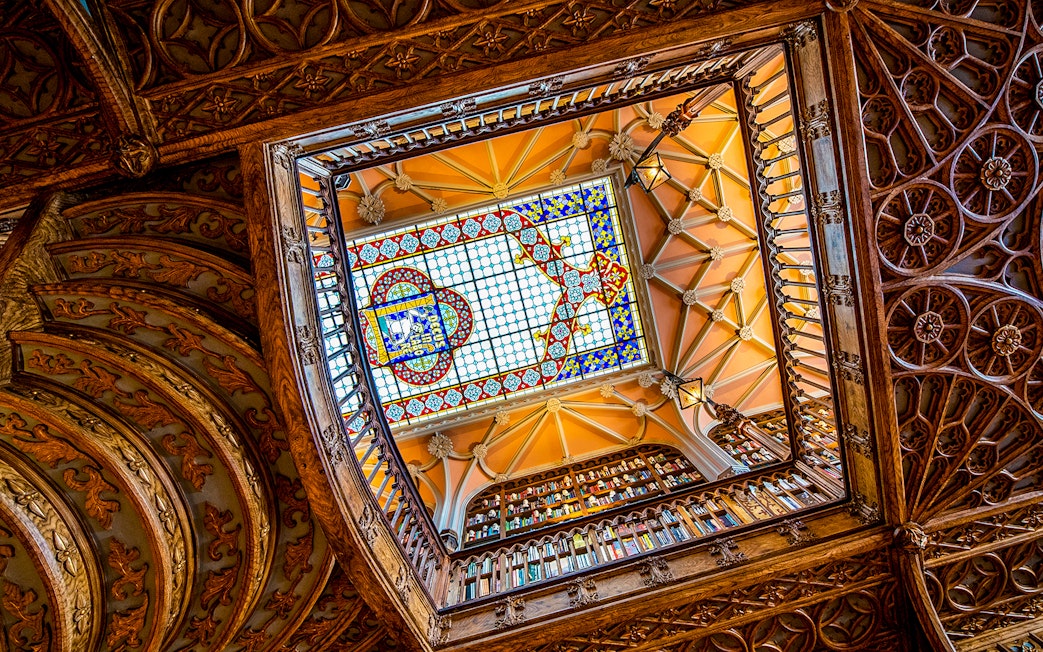 Lello Library's ornate stained glass ceiling viewed from below, Porto, Portugal.