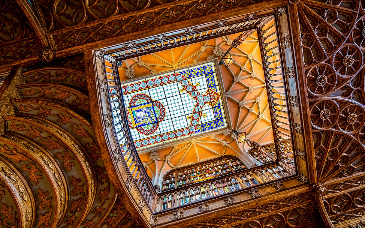 Lello Library's ornate stained glass ceiling viewed from below, Porto, Portugal.