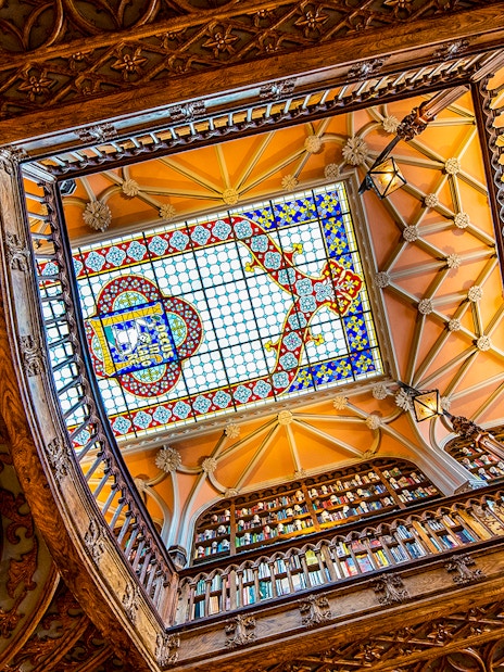 Lello Library's ornate stained glass ceiling viewed from below, Porto, Portugal.