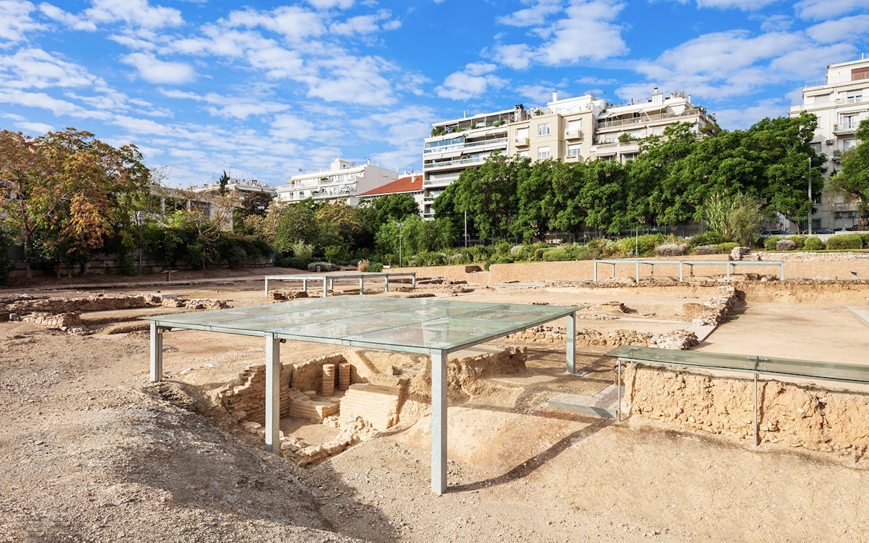 Archaeological site of Aristotle's School with modern buildings in the background, Athens, Greece.