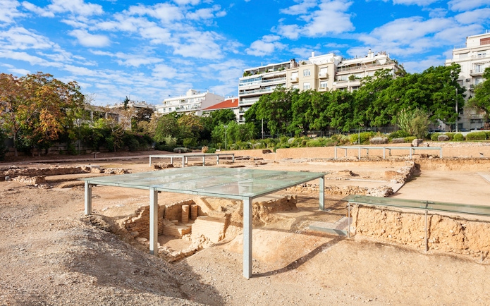 Archaeological site of Aristotle's School with modern buildings in the background, Athens, Greece.