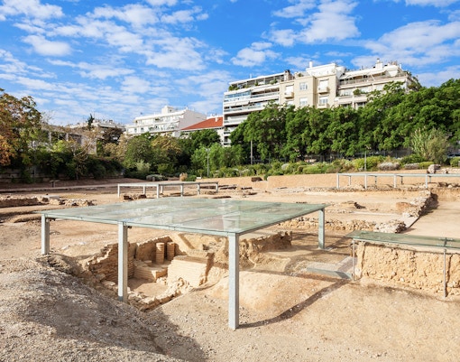 Archaeological site of Aristotle's School with modern buildings in the background, Athens, Greece.