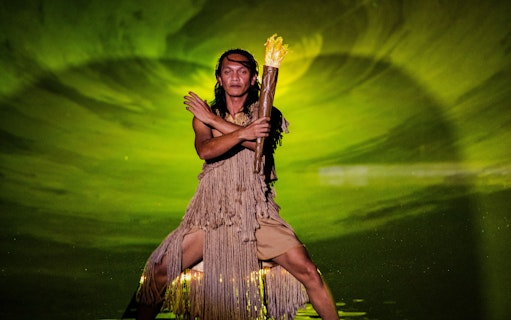 Man holding fire torch at The Legacy of a Generation Show.