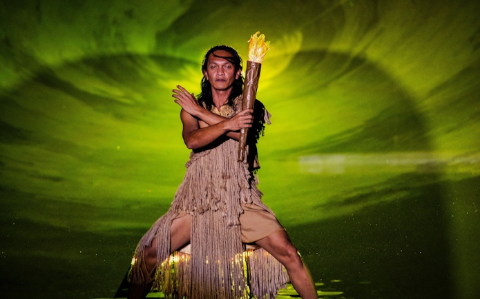 Man holding fire torch at The Legacy of a Generation Show.