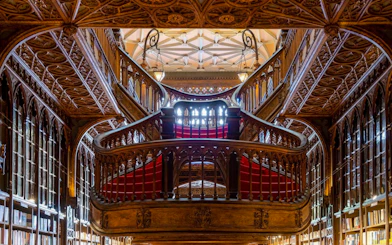 Intricate wooden staircase inside Livraria Lello, Porto.