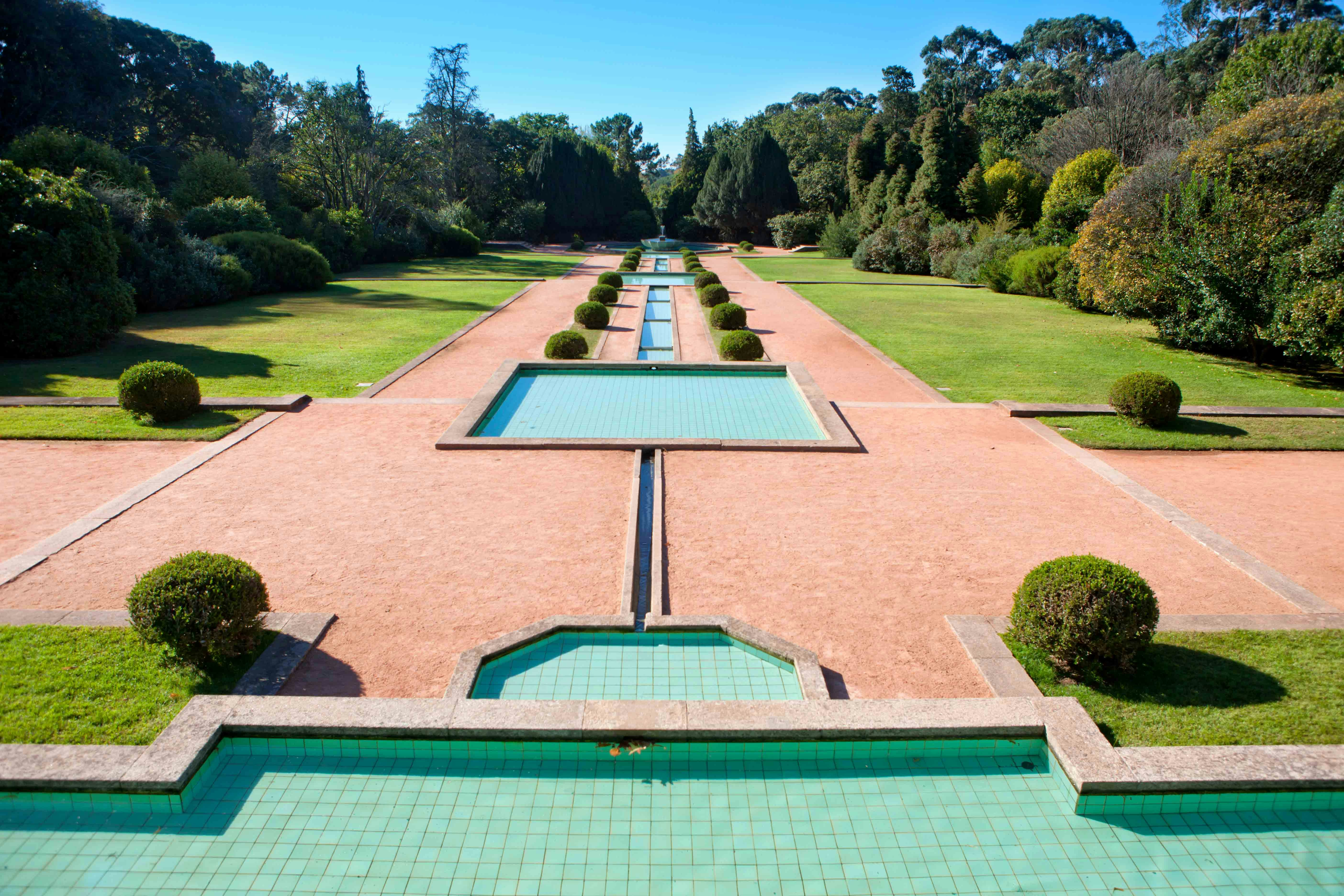 Visitors exploring the lush pathways of Serralves Garden in Portugal.