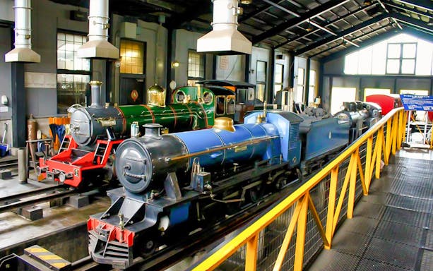Vintage trains inside a railway museum in Osaka, part of the JR Haruka Airport Express tour.