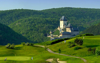 Karlstejn Castle surrounded by lush green hills in the Czech Republic.