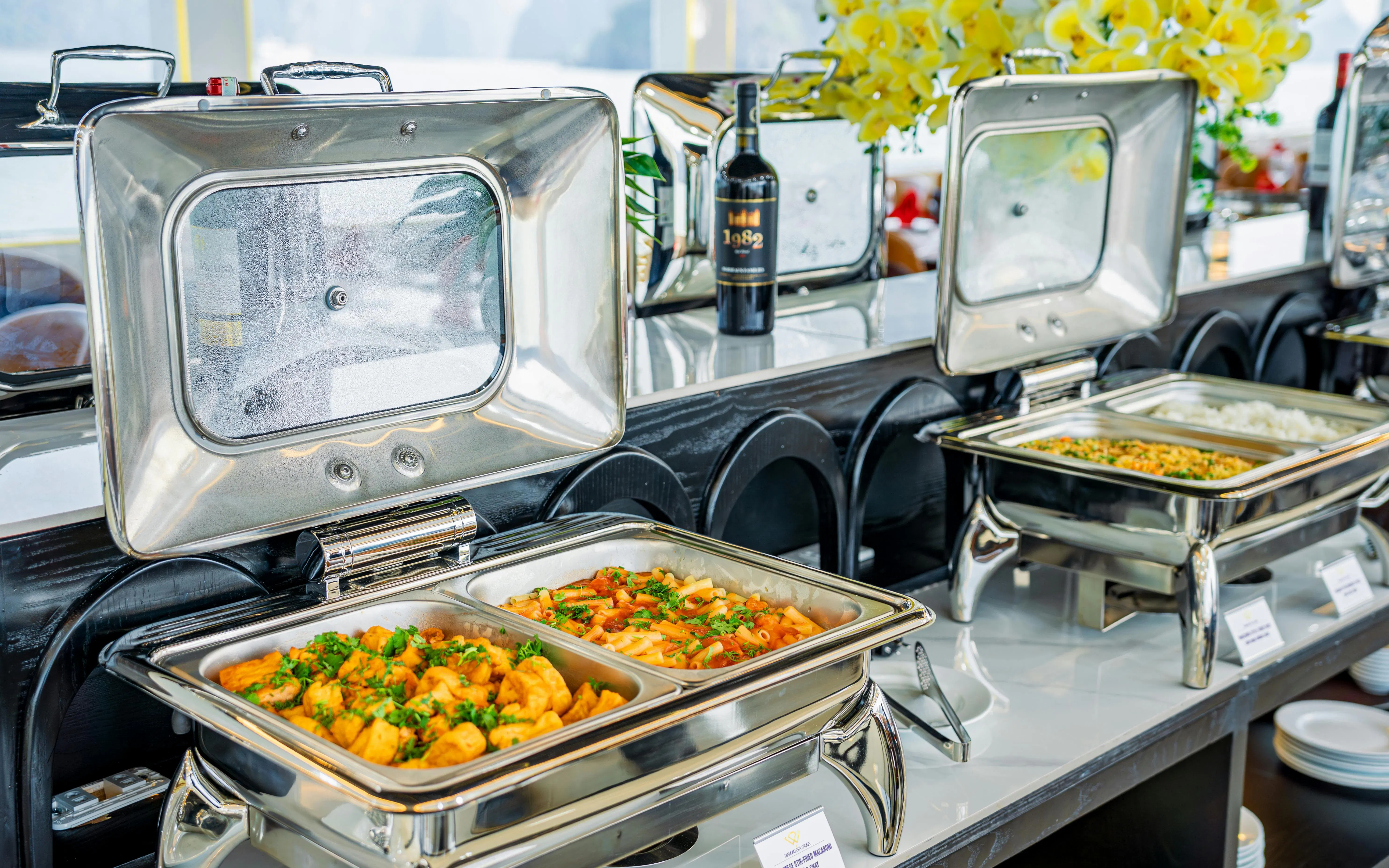 Buffet spread on Ha Long Bay Diamond Era Luxury Day Cruise with pasta and rice dishes.