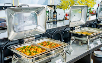 Buffet spread on Ha Long Bay Diamond Era Luxury Day Cruise with pasta and rice dishes.