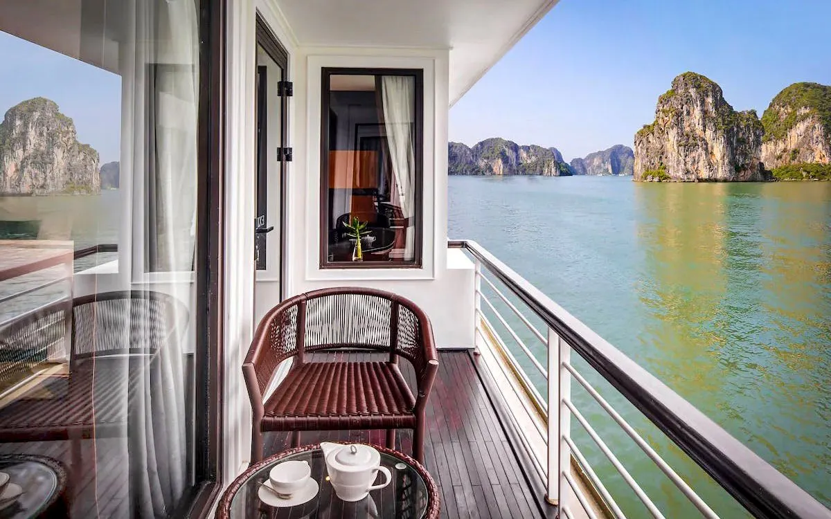 Premium cabin balcony view of Ha Long Bay limestone karsts on 5-star cruise.