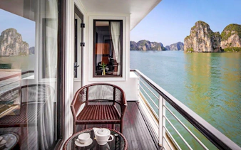 Premium cabin balcony view of Ha Long Bay limestone karsts on 5-star cruise.