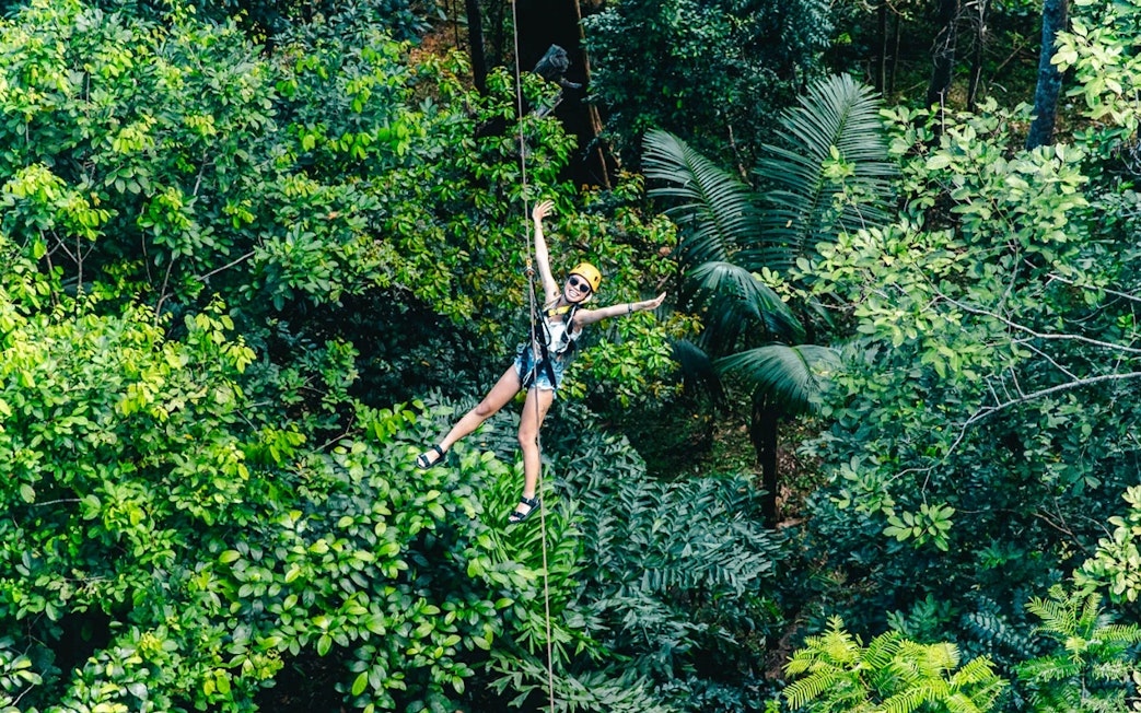 Ziplining through lush forest at Flying Hanuman, Phuket.