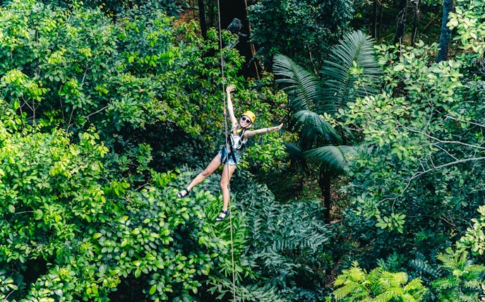 Ziplining through lush forest at Flying Hanuman, Phuket.