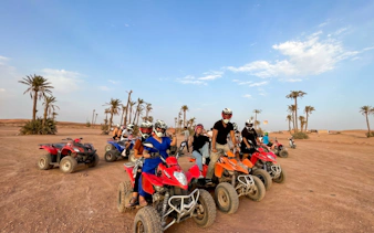 Group on quad bikes in Marrakech palm grove desert.