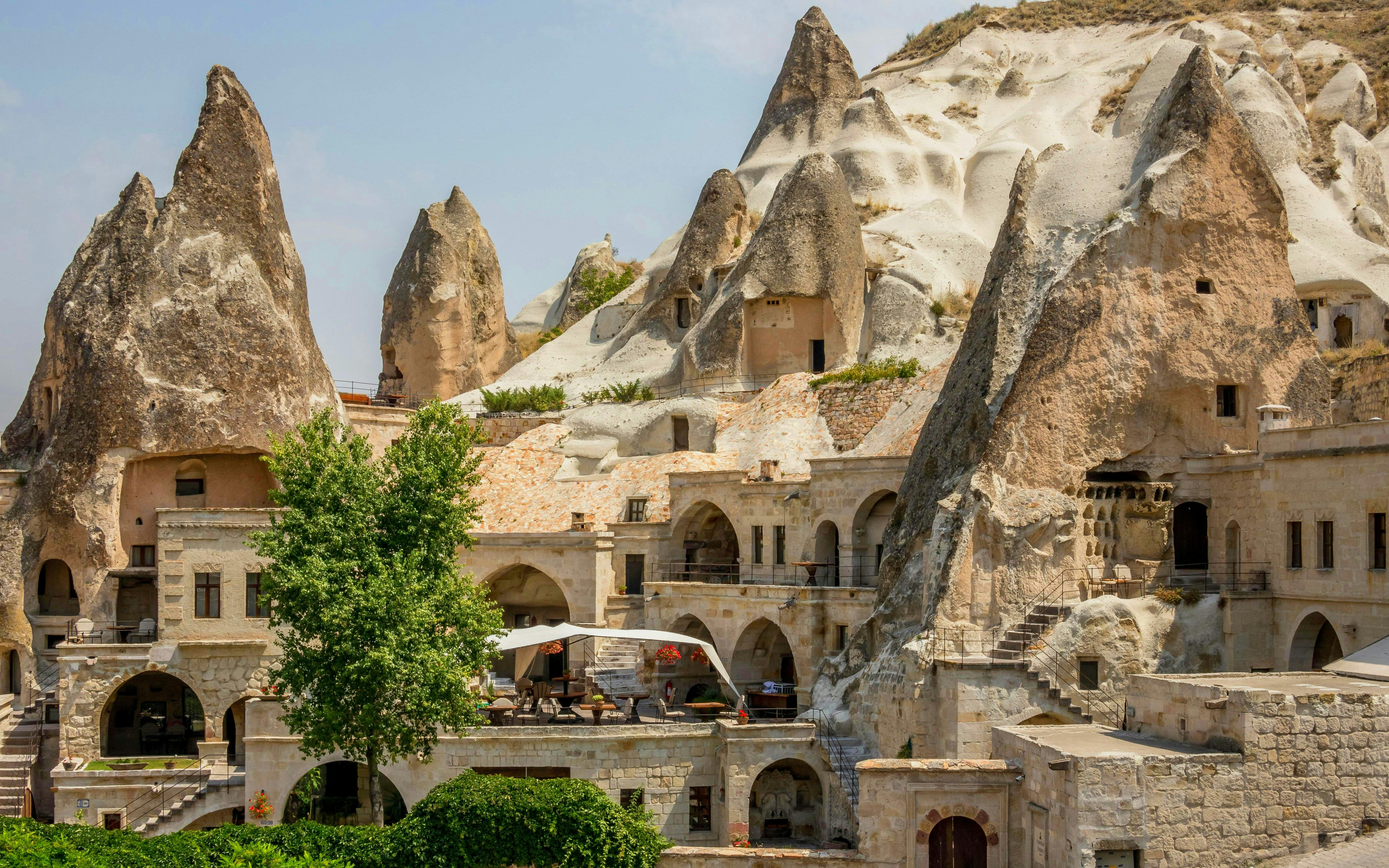 Cave houses in Goreme, Cappadocia, with unique rock formations and stone architecture.