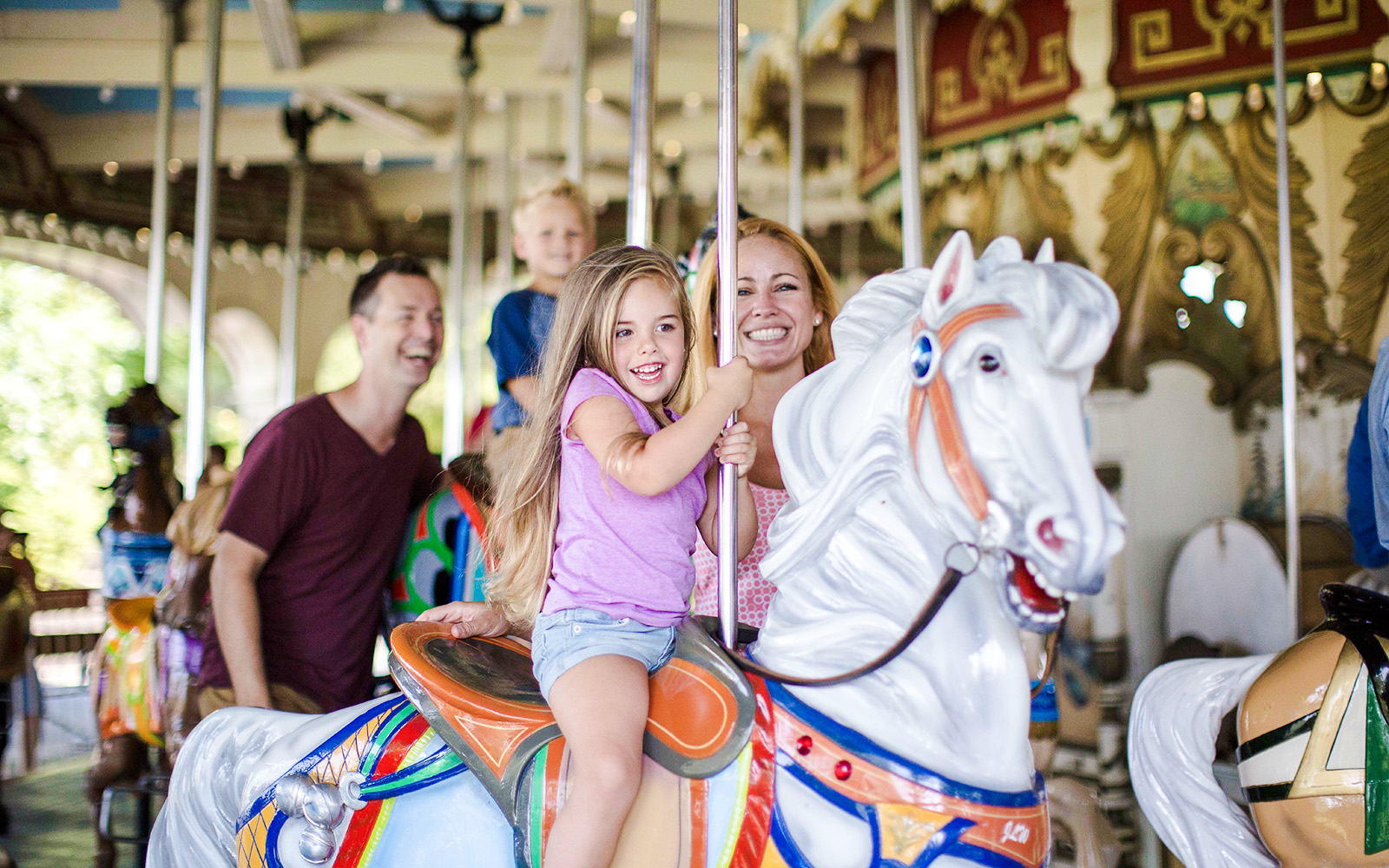 Family enjoying the Grand Carousel ride at Kings Island.