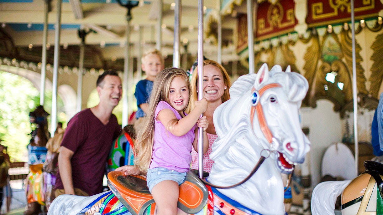 Family enjoying the Grand Carousel ride at Kings Island.