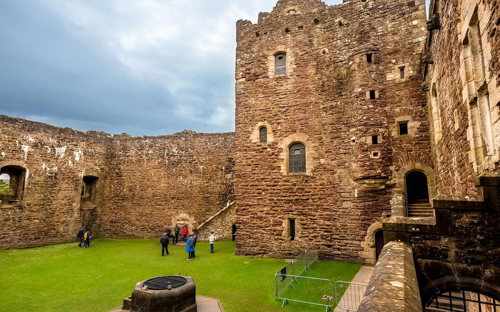 Urquhart Castle courtyard with visitors, part of Loch Ness cruise tour from Inverness.