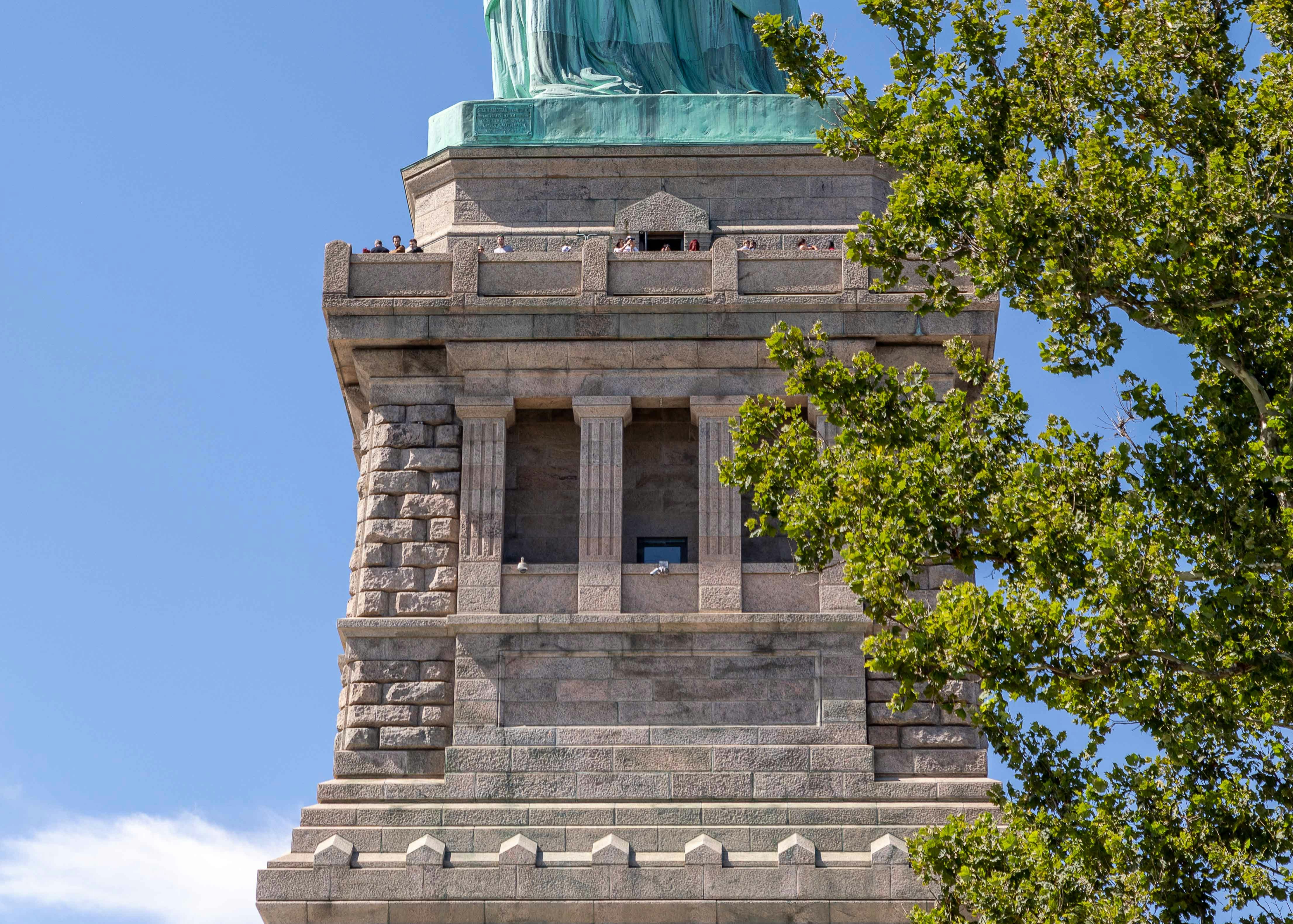 Statue of Liberty pedestal with visitors, New York City.