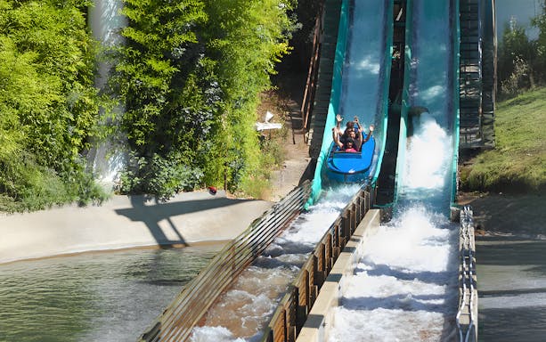 Visitors enjoying a log flume ride at Six Flags Magic Mountain.