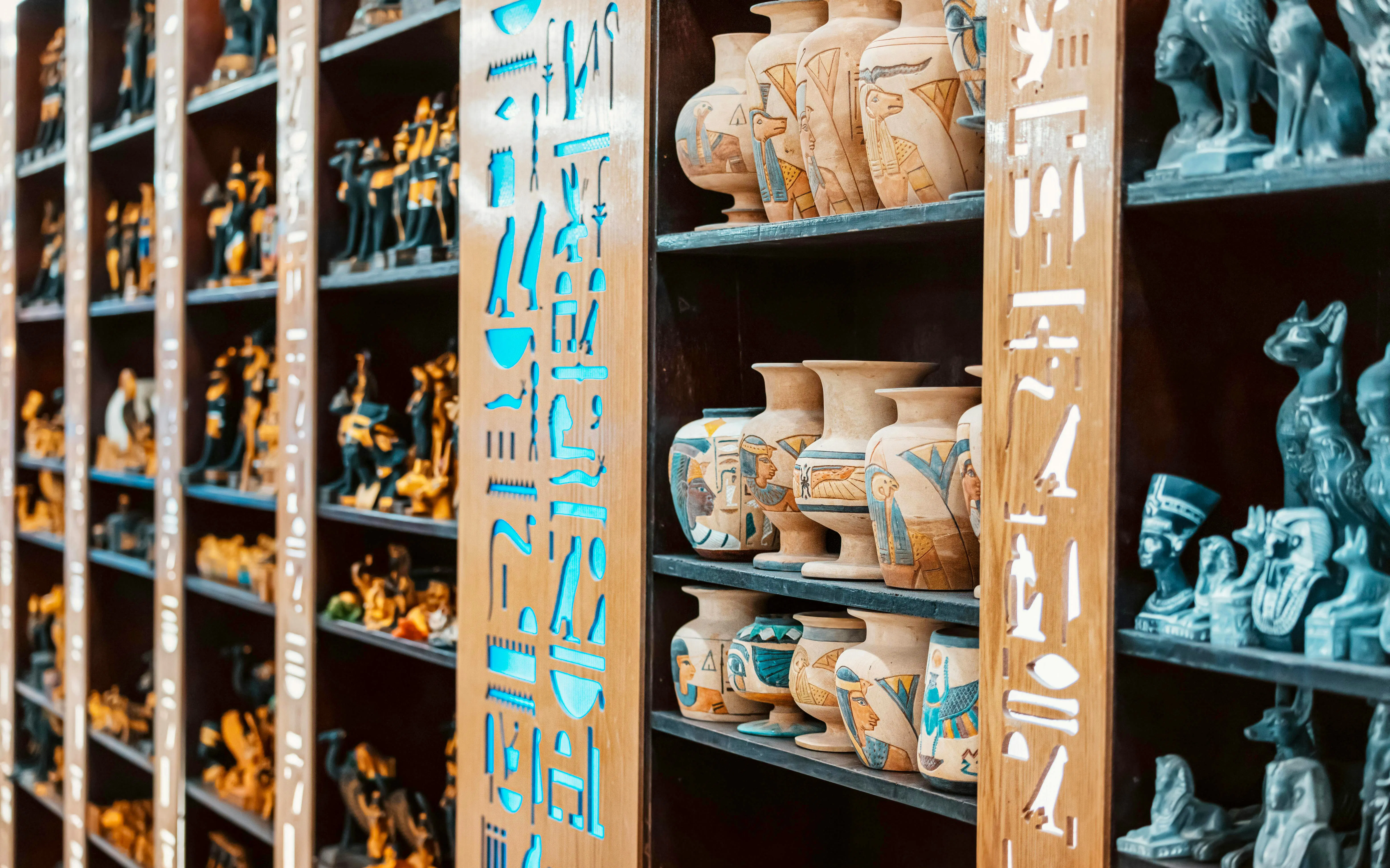 Luxor souvenir shop shelves with Egyptian vases and figurines.