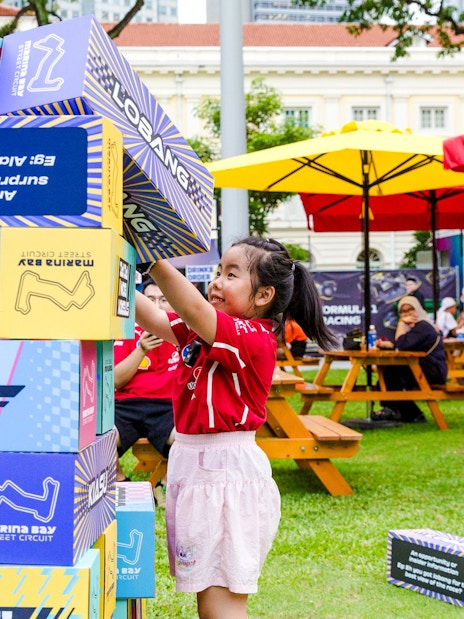 Child playing with large blocks at Marina Bay Street Circuit event, Singapore.
