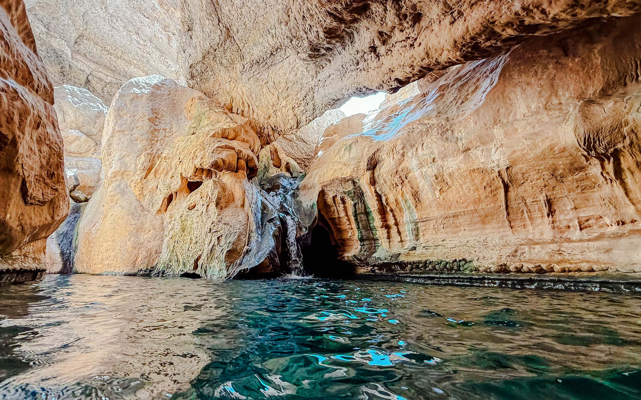 Rocky canyon with water pool in Wadi Shab, Oman.