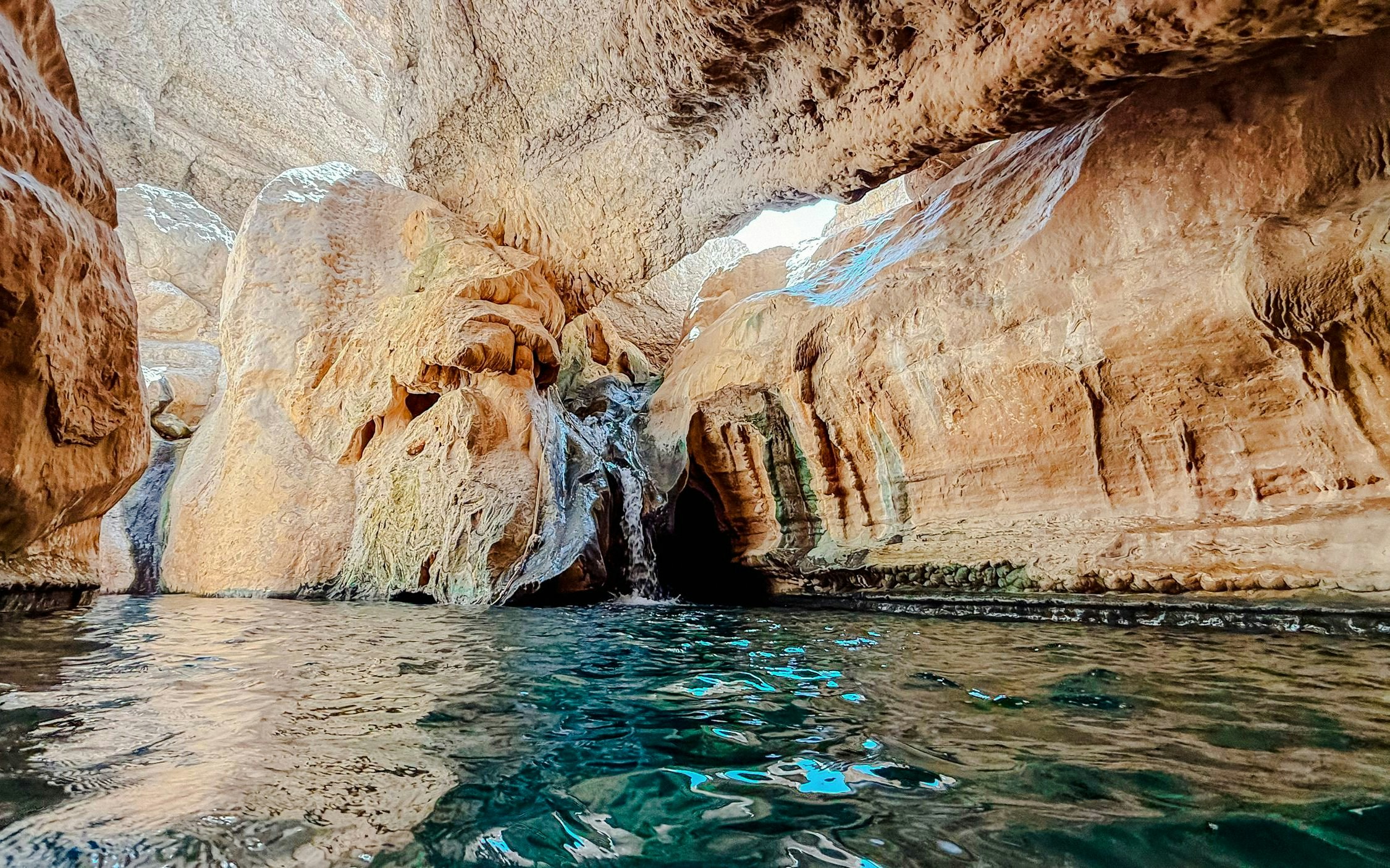 Rocky canyon with water pool in Wadi Shab, Oman.