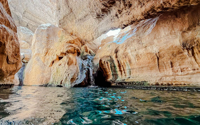 Rocky canyon with water pool in Wadi Shab, Oman.