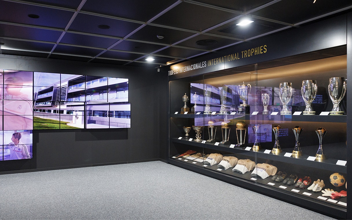 Trophy display inside Santiago Bernabeu Stadium with international awards.
